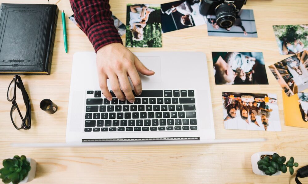 Top view of photographer using laptop