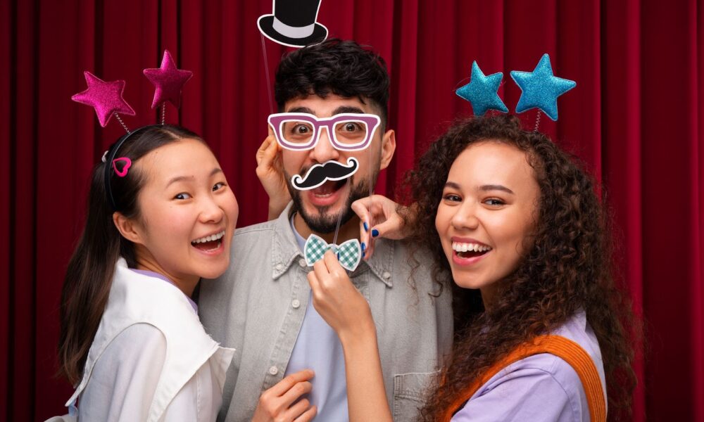 Three friends posing in photo booth