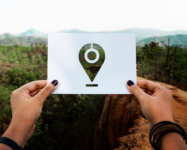 Hands holding paper with geolocation sign